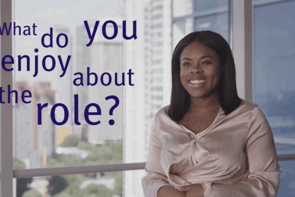 Woman smiling and on-text screen reading 'What do you enjoy about the role?'