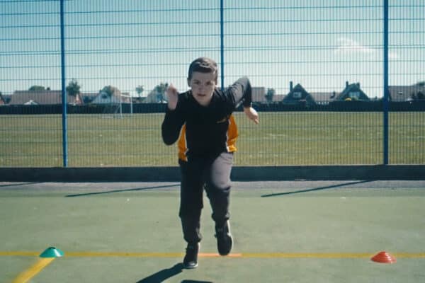 Boy running race towards camera