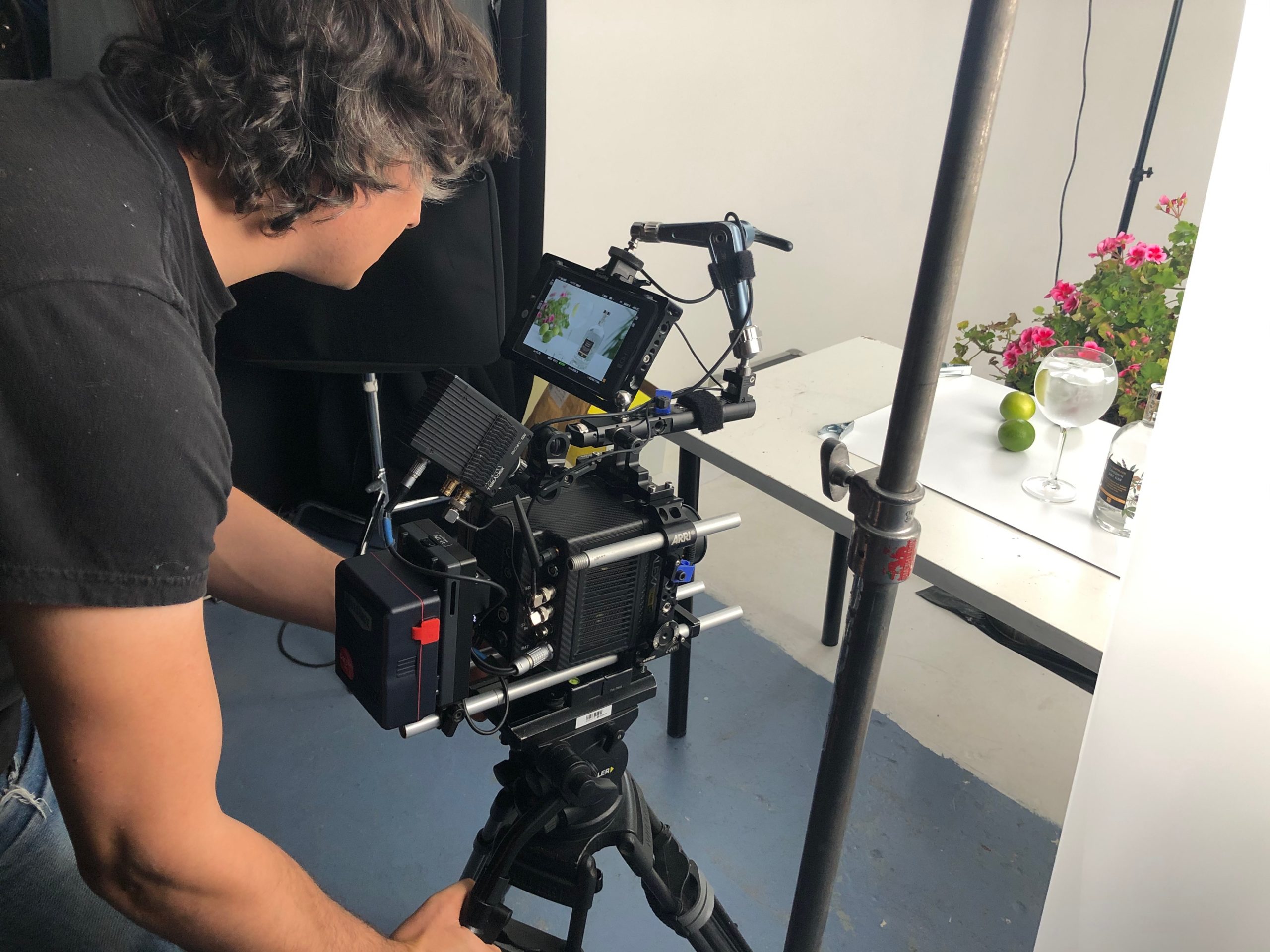 cameraperson in studio with video camera