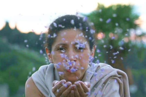 Actress blowing petals