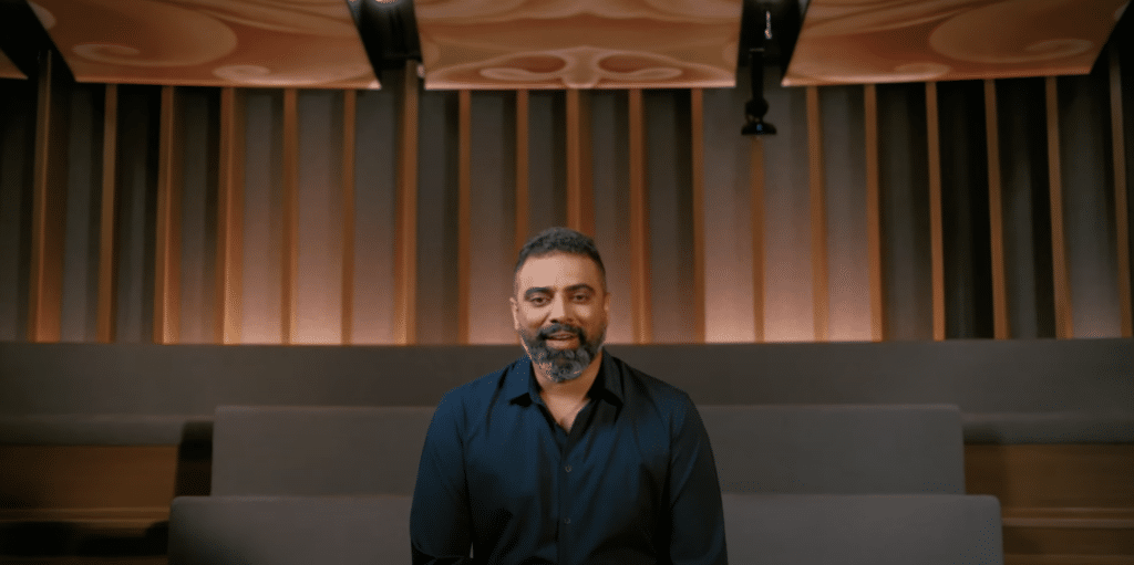 Interview wide shot of a man in a theatre