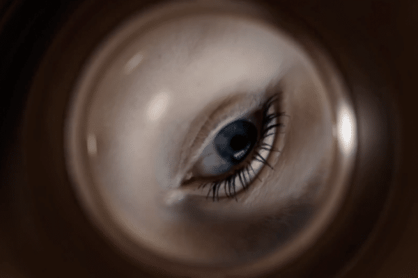 An eye looking down a tube