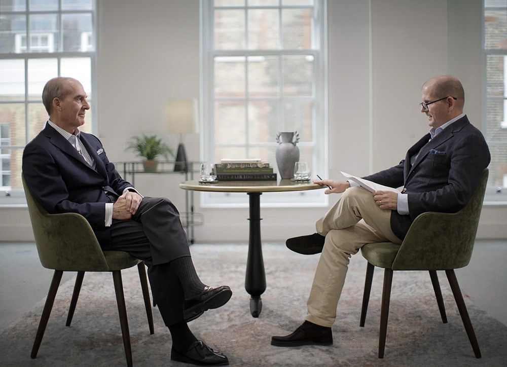 Two men having a fireside chat